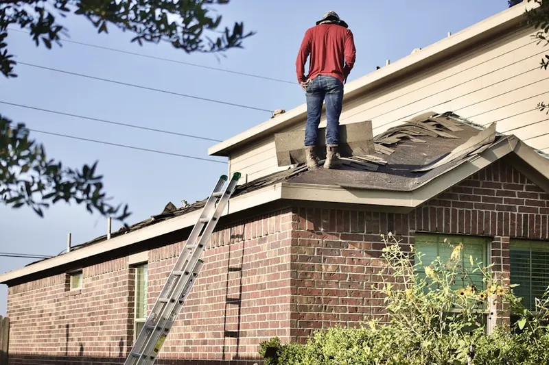 Professional roofer working on a residential roof in Ashley Pines